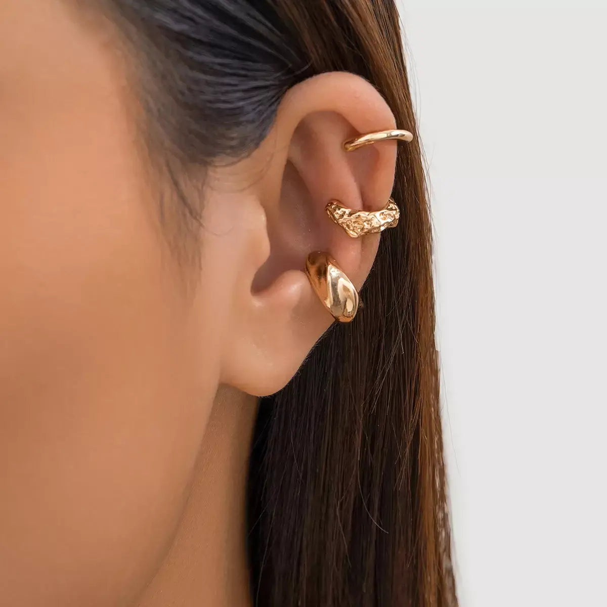 Three-piece vintage clip-on ear cuff set for women, non-piercing design.
Close-up of vintage-inspired non-piercing ear cuffs with delicate detailing.
Woman wearing trendy, non-piercing clip-on ear cuffs in a stylish arrangement.
Side view of the clip-on ear cuff set showcasing vintage and creative design.
Non-piercing ear cuff jewelry set displayed on a jewelry stand, ideal for gifting.