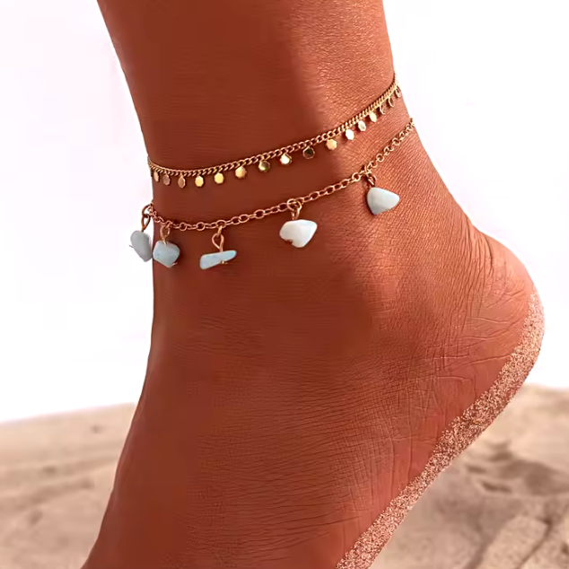 Close-up of 2-chain beaded shell anklet set with blue stones for women.
Summer beach anklet with multi-strand design, featuring blue stones and shells.
Stylish 2-chain anklet set with beaded shells and blue stones, perfect for summer.