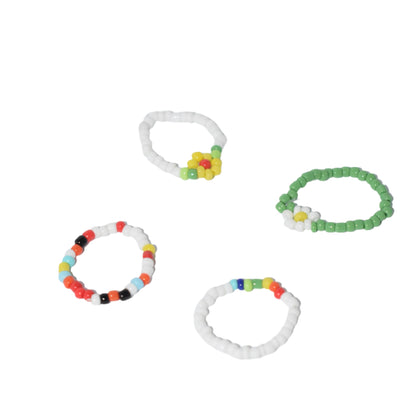 "Set of 4 Bohemian daisy flower beaded rings with colorful resin and acrylic beads."
"Close-up of 4 hand-woven elastic rings featuring daisy flower accents and colorful beads."
"Boho-chic set of 4 beaded rings with daisy flowers, made of resin and acrylic."
"Colorful elastic beaded rings set with daisy flower design, perfect for bohemian style."
"Set of 4 vibrant bohemian rings featuring daisy flowers, made from colorful resin and acrylic beads."