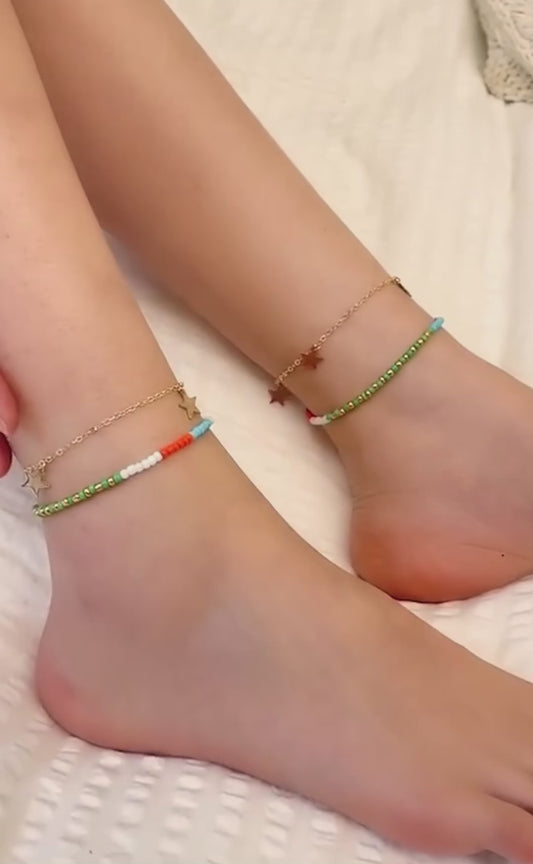 Adjustable boho anklet with colorful beads and star charms for a trendy look."
"Close-up of beaded star anklet, featuring vibrant colors and boho style."
"Colorful beaded anklet with star accents, perfect for casual wear."
"Bohemian-inspired adjustable anklet with multicolored beads and star charms."
"Stylish beaded anklet with stars, a colorful accessory for any outfit."